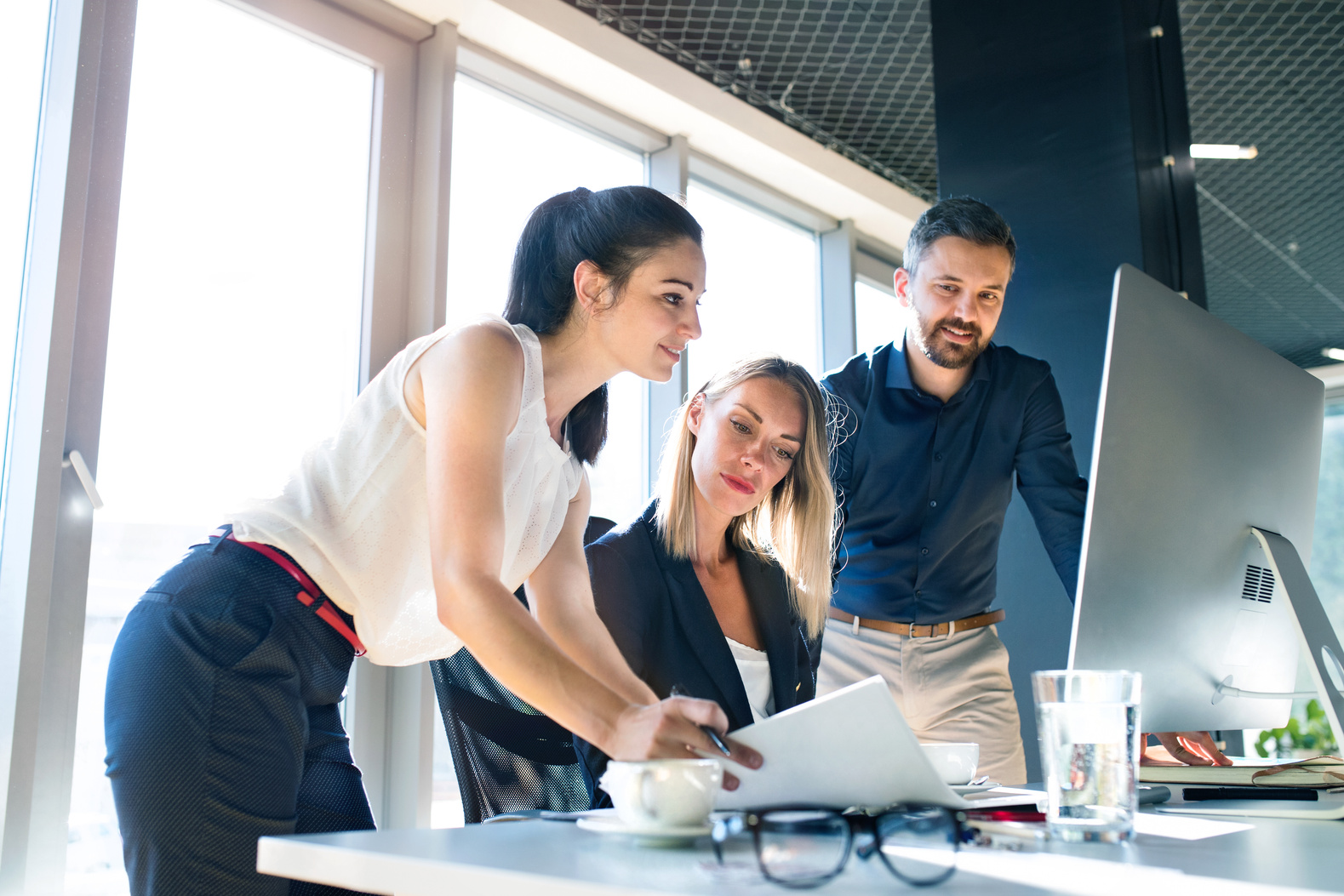 Three Business People in the Office Working